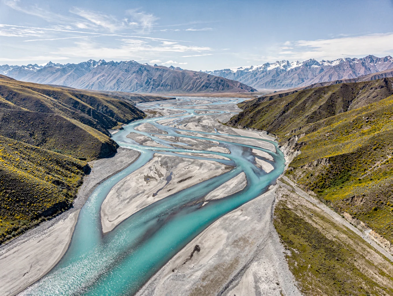 Glacial river braid flowing through braided valley below snowbound Aoraki Mount Cook